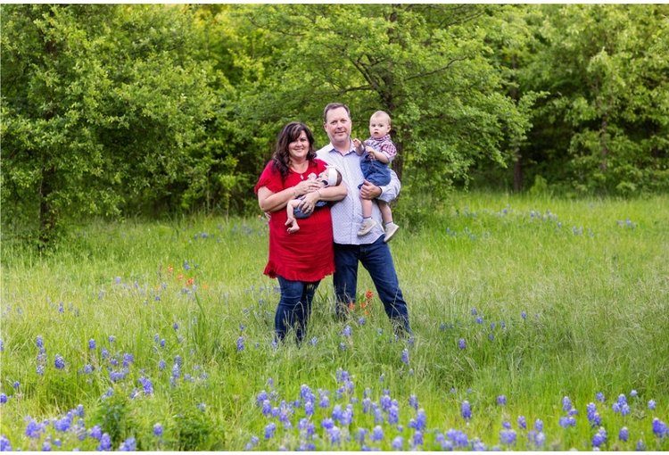 Jim and Bridy Ikey with two grandchildren in a field of wildflowers